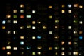 Night time lapse of Light in the windows of a multistory building. life in a big city