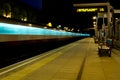 Night time long exposure picture of an Underground train speeding past a platform in London Royalty Free Stock Photo