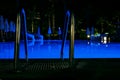 Night time pool handrails in the hotel water is blue