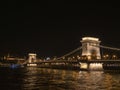 a night time side view of chain bridge and river danube in budapest Royalty Free Stock Photo