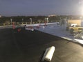 Night time view of the removal of Modified Cap sheet Commercial flat roof conversion to TPO with safety flags Royalty Free Stock Photo