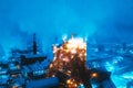 Night top view of steel plant at night with smokestacks and fire blazing out of the pipe. Industrial panoramic landmark with blast Royalty Free Stock Photo