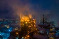 Night top view of steel plant at night with smokestacks and fire blazing out of the pipe. Industrial panoramic landmark blast Royalty Free Stock Photo