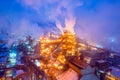 Night top view of steel plant at night with smokestacks and fire blazing out of the pipe. Industrial panoramic landmark Royalty Free Stock Photo