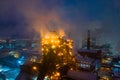 Night top view of steel plant at night with smokestacks and fire blazing out of the pipe. Industrial panoramic landmark Royalty Free Stock Photo