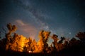 Night touristic camp with fire under a starry sky Royalty Free Stock Photo