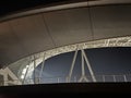 In the night, the towering structure of the sports stadium resembles a magnificent castle standing in the heart of the city Royalty Free Stock Photo