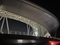 In the night, the towering structure of the sports stadium resembles a magnificent castle standing in the heart of the city Royalty Free Stock Photo