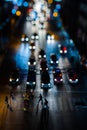 Night traffic in Bangkok. People cross the street at a pedestrian crossing. Car headlights are out of focus in the background Royalty Free Stock Photo