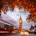 Night traffic jam with autumn leaves against Big Ben in London, England, UK Royalty Free Stock Photo