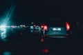 Night traffic jam in bed rainy weather. road danger during hurricane. red and blue tail lights of cars Royalty Free Stock Photo