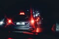 Night traffic jam in bed rainy weather. road danger during hurricane. red and blue tail lights of cars Royalty Free Stock Photo