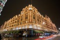 Night traffic and street scenery in a typical rainy day in United kingdom near Harrods Department Store in London. Night urban Royalty Free Stock Photo