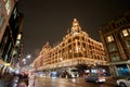 Night traffic and street scenery in a typical rainy day in United kingdom near Harrods Department Store in London. Night urban Royalty Free Stock Photo