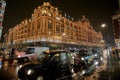 Night traffic and street scenery in a typical rainy day in United kingdom near Harrods Department Store in London. Night urban Royalty Free Stock Photo