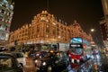 Night traffic and street scenery in a typical rainy day in United kingdom near Harrods Department Store in London. Night urban