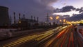 Night traffic on urban thoroughfare along industrial zone