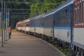 Night train with sleeping coaches and car motorcycle coaches Kysak station Royalty Free Stock Photo