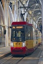 Night tram riding around city. Modern tram going in evening city