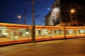 Night tram riding around city. Modern tram going in movement in evening city Royalty Free Stock Photo