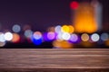 Night twilight blurred light bokeh in downtown bangkok empty of dark wood table abstract background for montage product display
