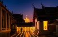 Night Urban City Skyline of Landmark Bangkok. Wat Saket. Night scene of Phu Khao Thong Golden Mountain and monk reading a book Royalty Free Stock Photo