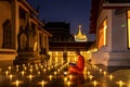 Night Urban City Skyline of Landmark Bangkok. Wat Saket. Night scene of Phu Khao Thong Golden Mountain and monk reading a book Royalty Free Stock Photo