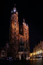 Night vertical photo of the central square Rynok Glavny with St. Mary\'s Church in Krakow Poland