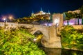 Night view of Alcantara bridge over river Tajo with Alcazar castle at background at Toledo, Spain Royalty Free Stock Photo