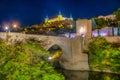 Night view of Alcantara bridge over river Tajo with Alcazar castle at background at Toledo, Spain Royalty Free Stock Photo