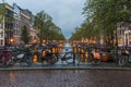 Night view of Amsterdam cityscape with canal, bridge and typical Dutch Houses. Amsterdam, Netherlands Royalty Free Stock Photo