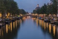 Night view of Amsterdam cityscape with canal, bridge and typical Dutch Houses. Amsterdam, Netherlands Royalty Free Stock Photo