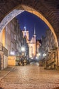 Gdansk, Poland, night view through gothic archway onto Mariacka street