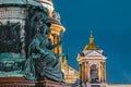 Night view of the ancient statues of stucco and the dome of St. Isaac`s Cathedral Saint-Petersburg.