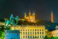 Night view of Basilica Notre-Dame de Fourviere viewed behind statue of Louis XIV in Lyon, France Royalty Free Stock Photo