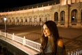 Night view of beautiful young woman in Plaza de Espana, Seville, Spain. Royalty Free Stock Photo