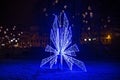 Night view of the big electric Christmas decorations with blue lights on the street in Riga. Royalty Free Stock Photo