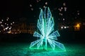 Night view of the big electric Christmas decorations with green lights on the street in Riga. Latvia Royalty Free Stock Photo