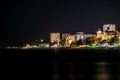 Night view of Black Sea resort coast with promenade and ferris wheel. Long exposure