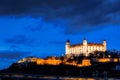 Night view of Bratislava castle from river surface with dramtic sunset skyline Royalty Free Stock Photo