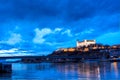 Night view of Bratislava castle from river surface with dramtic sunset skyline Royalty Free Stock Photo