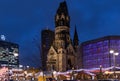 Night view of Breitscheidplatz square with ancient clock tower of Kaiser Wilhelm Memorial Church named `the hollow tooth` Berlin.