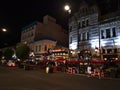 Night view of busy Government St in historic Victoria downtown, Vancouver Island with the entrance to Bastion Square.