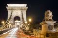 Night view of Chain Bridge over Danube River and stone lion. Budapest, Hungary Royalty Free Stock Photo