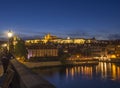 Night view from Charles bridge of illuminated St. Vitus Cathedral gothic churche and Prague Castle panorama with