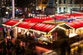 London, UK/Europe; 20/12/2019: Night view of Christmas market in Trafalgar Square. Long exposure shot with burred people walking Royalty Free Stock Photo