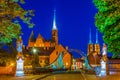 Night view of church of the Holy Cross and St Bartholomew and cathedral of saint john the baptist through a steel bridge Royalty Free Stock Photo