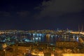 Night view of the city, a lot of lights ships and reflected glare on the water