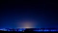 Night view of a city, sky full of stars and sunlight at sunset Royalty Free Stock Photo