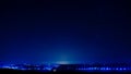 Night view of a city, sky full of stars and sunlight at sunset Royalty Free Stock Photo